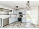 Bright kitchen featuring stainless steel appliances, blue cabinets, and access to the backyard at 9676 W Constellation Dr, Pendleton, IN 46064