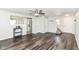 Spacious living room with wood-look floors, open to the kitchen, with ample natural light and a ceiling fan at 9676 W Constellation Dr, Pendleton, IN 46064