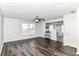 Open living room featuring sleek wood-look floors, a ceiling fan, and bright natural light at 9676 W Constellation Dr, Pendleton, IN 46064