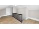 Finished attic space with light hardwood floors and a painted black metal safety railing at 1016 Churchman Ave, Indianapolis, IN 46203