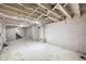 Unfinished basement with painted walls, exposed beams and piping, and a concrete floor at 1016 Churchman Ave, Indianapolis, IN 46203