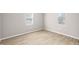 Bright bedroom with neutral walls, wood flooring, and sun-filled windows at 1016 Churchman Ave, Indianapolis, IN 46203