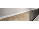 Finished hallway space with light hardwood floors and a painted black metal safety railing at 1016 Churchman Ave, Indianapolis, IN 46203