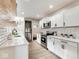 Modern kitchen with sleek stainless steel appliances and pristine white cabinetry and quartz countertops at 1016 Churchman Ave, Indianapolis, IN 46203
