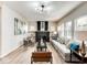 Stylish living room featuring light wood floors, a modern sofa, and an attractive black fireplace at 1016 Churchman Ave, Indianapolis, IN 46203