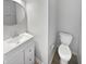 Half bathroom with modern vanity, brushed nickel faucet, and white toilet at 10366 Camby Xing, Fishers, IN 46038