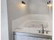Bathroom with a large corner jacuzzi tub, mosaic tile trim, and brushed nickel hardware at 10366 Camby Xing, Fishers, IN 46038