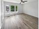 Bright bedroom features large windows, a ceiling fan, and new hardwood floors at 10366 Camby Xing, Fishers, IN 46038