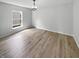 Bright bedroom with new floors, a modern light fixture, and a large window at 10366 Camby Xing, Fishers, IN 46038