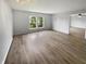 Spacious bedroom with wood-look floors, two windows, and a ceiling fan at 10366 Camby Xing, Fishers, IN 46038