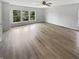 Large bedroom featuring wood-look floors, natural light from the windows, and a ceiling fan at 10366 Camby Xing, Fishers, IN 46038