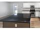 Updated kitchen featuring stainless steel appliances, granite counters, white cabinets, and a kitchen island at 10366 Camby Xing, Fishers, IN 46038