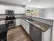 Modern kitchen with stainless steel appliances, granite countertops, and white cabinets at 10366 Camby Xing, Fishers, IN 46038