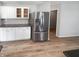 Kitchen with stainless steel refrigerator, white cabinets, granite countertops, and subway tile backsplash at 10366 Camby Xing, Fishers, IN 46038