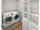 Well-organized laundry room with modern appliances and built-in shelving at 10366 Camby Xing, Fishers, IN 46038
