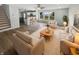 Bright living room featuring hardwood floors, neutral colors, and an open floor plan to the kitchen at 10366 Camby Xing, Fishers, IN 46038