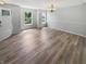 Bright living room featuring wood-look floors, neutral walls, and ample natural light from the windows at 10366 Camby Xing, Fishers, IN 46038