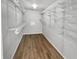 Bright walk-in closet with multiple shelves and durable wood flooring at 10366 Camby Xing, Fishers, IN 46038