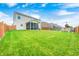 Expansive backyard with lush green lawn, screened in porch, wood fence, and play equipment at 10447 Pintail Ln, Indianapolis, IN 46239