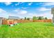 Expansive backyard with lush green grass and a wooden playset for outdoor fun at 10447 Pintail Ln, Indianapolis, IN 46239