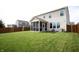 Well-maintained backyard with green grass, wooden fence, screened-in porch, and barbecue grill at 10447 Pintail Ln, Indianapolis, IN 46239