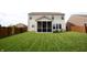 Expansive backyard with manicured lawn and screened-in porch, perfect for outdoor living at 10447 Pintail Ln, Indianapolis, IN 46239