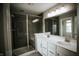 Modern bathroom features a large shower with glass door and double sink vanity at 10447 Pintail Ln, Indianapolis, IN 46239