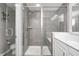 Modern bathroom with a glass-enclosed shower, and a double vanity at 10447 Pintail Ln, Indianapolis, IN 46239