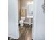 Bathroom with a pedestal sink, a toilet and cream-colored towels hanging near a silver-colored mirror at 10447 Pintail Ln, Indianapolis, IN 46239