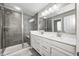 Modern bathroom featuring a glass-enclosed shower, a double vanity, and great lighting at 10447 Pintail Ln, Indianapolis, IN 46239
