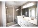 Modern bathroom showcasing a glass-enclosed shower, double sinks with sleek fixtures, and a spacious vanity at 10447 Pintail Ln, Indianapolis, IN 46239