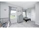 Playful room with a crib, dresser, and a table set by the window at 10447 Pintail Ln, Indianapolis, IN 46239