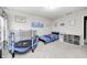 Cozy bedroom with a trampoline, bed, gray carpet, and plenty of wall art at 10447 Pintail Ln, Indianapolis, IN 46239