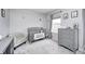Serene Bedroom featuring a gray crib, patterned chair, and soft gray walls at 10447 Pintail Ln, Indianapolis, IN 46239