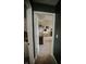 A bedroom featuring a vanity with a round mirror and neutral carpet at 10447 Pintail Ln, Indianapolis, IN 46239