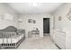 A Bedroom room with one white crib and one grey crib, dresser, and decorative wall art at 10447 Pintail Ln, Indianapolis, IN 46239