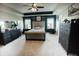 Spacious bedroom boasts tray ceilings, two windows, tufted headboard and dark wood dressers at 10447 Pintail Ln, Indianapolis, IN 46239