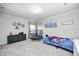 Bright bedroom featuring neutral walls, a grey dresser, and a vibrant blue bedspread at 10447 Pintail Ln, Indianapolis, IN 46239