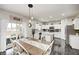 Open dining area with stylish table and chairs, leading to a modern kitchen with white cabinets at 10447 Pintail Ln, Indianapolis, IN 46239