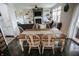 Open-concept dining room with wooden table, chairs, seamlessly connecting to the bright, modern living space at 10447 Pintail Ln, Indianapolis, IN 46239