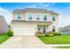 Charming two-story home with a well-manicured lawn, a two car garage, and beautiful landscaping at 10447 Pintail Ln, Indianapolis, IN 46239