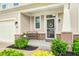 Inviting front porch with bench, brick accents, and a storm door featuring a 'Sweet Home' sign at 10447 Pintail Ln, Indianapolis, IN 46239