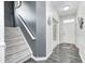 Bright foyer features hardwood floors, staircase with gray accent wall, and door leading to the living area at 10447 Pintail Ln, Indianapolis, IN 46239