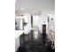 Bright hallway with dark wood-style floors leading past the kitchen area with stainless steel fridge at 10447 Pintail Ln, Indianapolis, IN 46239