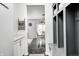 Hallway with storage lockers and a view into the dining area with natural lighting at 10447 Pintail Ln, Indianapolis, IN 46239