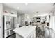 Open-concept kitchen and dining area, showcasing stainless steel appliances and a view into the living room at 10447 Pintail Ln, Indianapolis, IN 46239