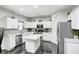 Modern kitchen with white cabinets, stainless steel appliances, central island, and stylish backsplash at 10447 Pintail Ln, Indianapolis, IN 46239