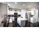 Bright kitchen with white cabinets, stainless steel appliances, an island and dark wood-style floors at 10447 Pintail Ln, Indianapolis, IN 46239