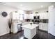 Modern kitchen with white cabinets, stainless steel appliances, an island, and granite countertops at 10447 Pintail Ln, Indianapolis, IN 46239