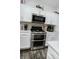 Kitchen featuring stainless steel oven/microwave, and white cabinets at 10447 Pintail Ln, Indianapolis, IN 46239